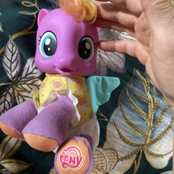 Size: 1200x1200 | Tagged: safe, baby, baby daze (so soft newborn), baby pony, bedroom, blue wings, cute, diadazes, diaper, doll, female, filly, foal, g4, g4 logo, hand, human, imported from derpibooru, indoors, irl, logo, my little pony logo, newborn, pegasus, photo, pony, so soft, so soft newborn sunny daze, sunny daze (so soft newborn), toy, wings