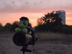 Size: 4096x3072 | Tagged: safe, oc, oc:filly anon, camera, female, filly, foal, grass, imported from derpibooru, irl, lying down, oc only, outdoors, photo, plushie, prone, solo
