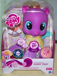 Size: 628x842 | Tagged: safe, baby, baby pony, box, box cover, cute, diadazes, diaper, electronic toy, female, filly, foal, g4, g4 logo, hasbro, hasbro logo, hnnng, hub logo, implied wings, imported from derpibooru, indoors, irl, logo, my little pony logo, official, pacifier, pegasus, photo, pony, simple background, so soft, so soft newborn sunny daze, speech bubble, sunny daze (so soft newborn), the hub, toy, try me, white background, wings